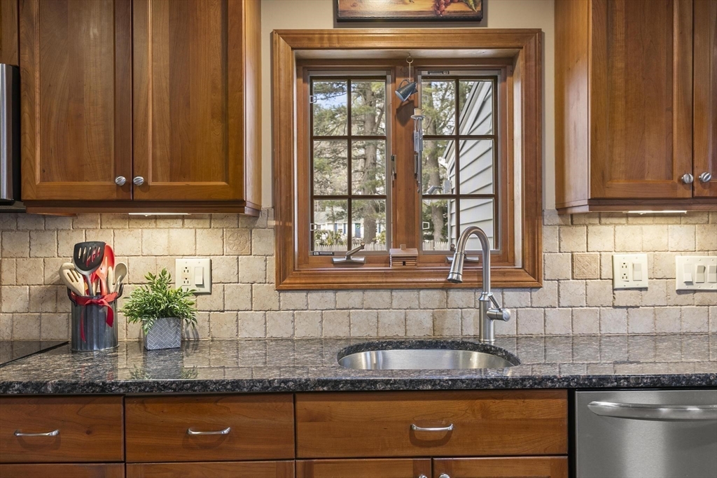 19 Dustin Road Reading, MA 01867 - Photo 16 of 33 a kitchen with granite countertop stainless steel appliances a sink and a counter top space