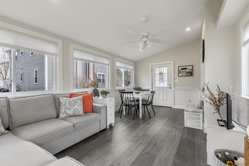 19 Dustin Road Reading, MA 01867 - Photo 20 of 33 a living room with furniture wooden floor and a flat screen tv