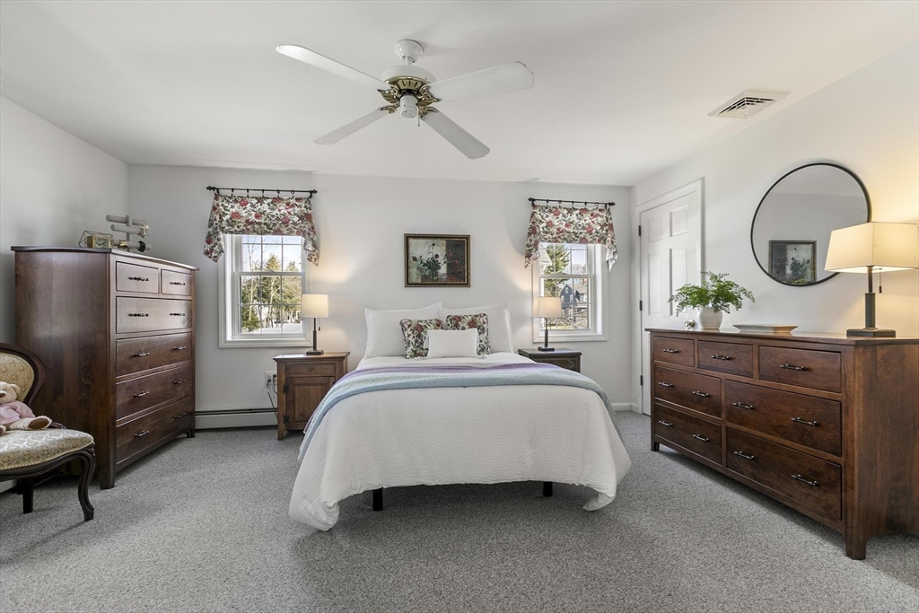 19 Dustin Road Reading, MA 01867 - Photo 23 of 33 a spacious bedroom with a bed and a dresser