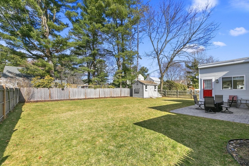 19 Dustin Road Reading, MA 01867 - Photo 30 of 33 a view of a house with a backyard and a tree