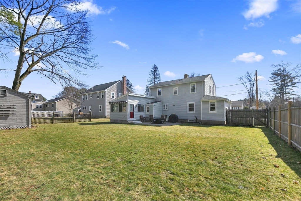 19 Dustin Road Reading, MA 01867 - Photo 4 of 33 a large house with a large tree in front of it