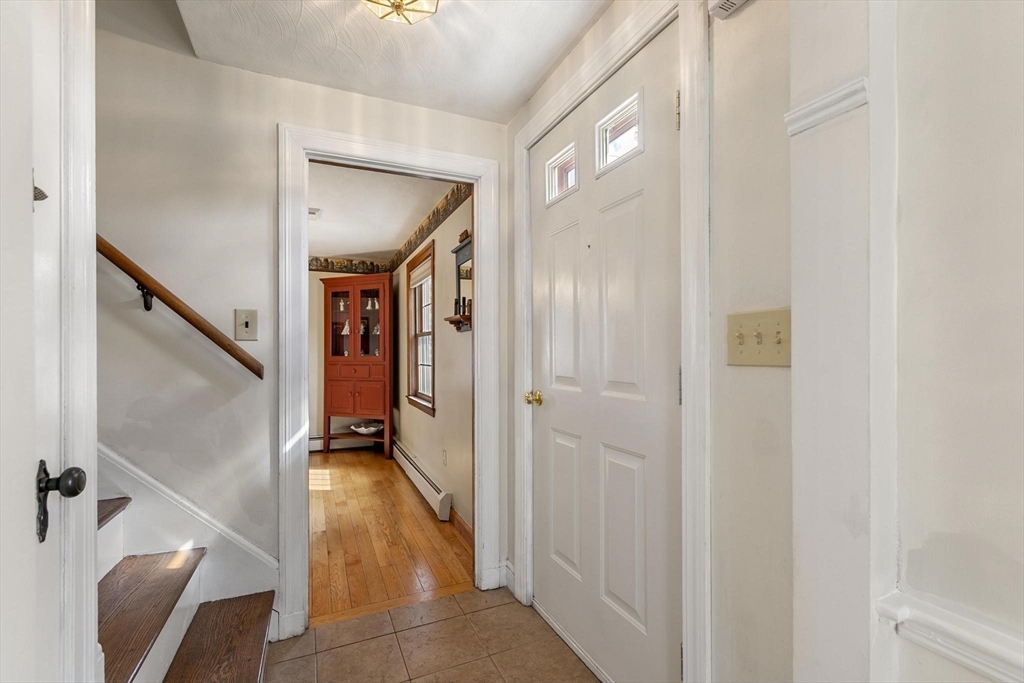 19 Dustin Road Reading, MA 01867 - Photo 6 of 33 a view of hallway with stairs and a couch