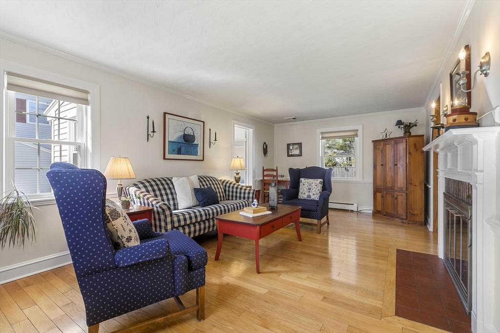 19 Dustin Road Reading, MA 01867 - Photo 8 of 33 a living room with furniture and a fireplace