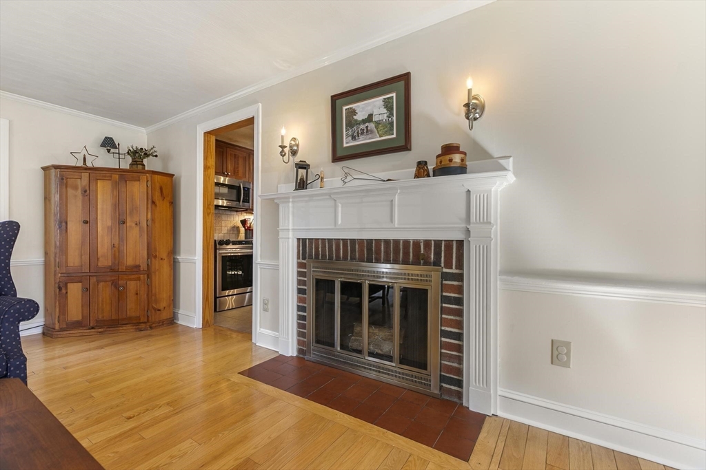 19 Dustin Road Reading, MA 01867 - Photo 9 of 33 a living room with furniture and a fireplace