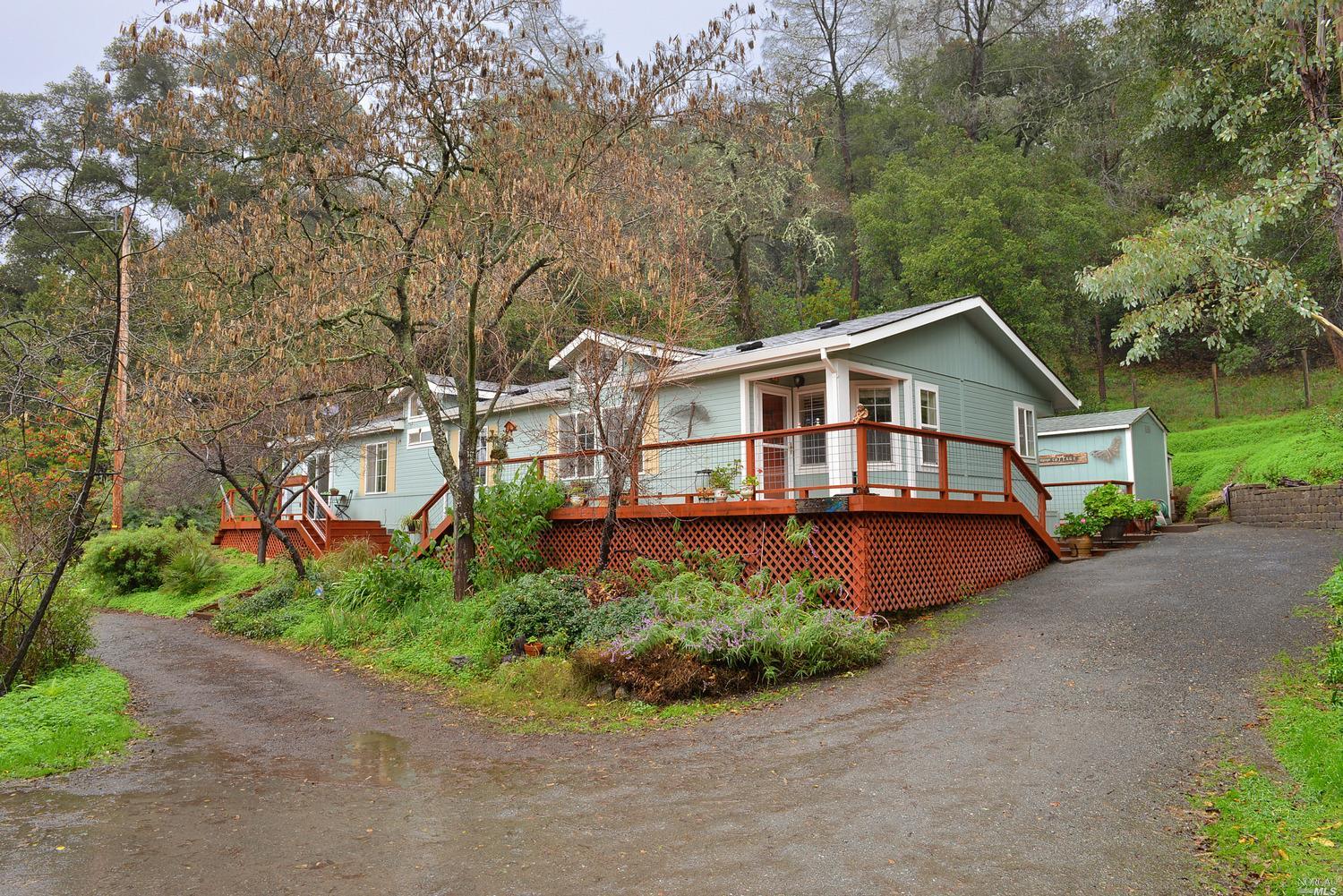 Front of the House showing deck off the living room and deck off of the master bedroom.