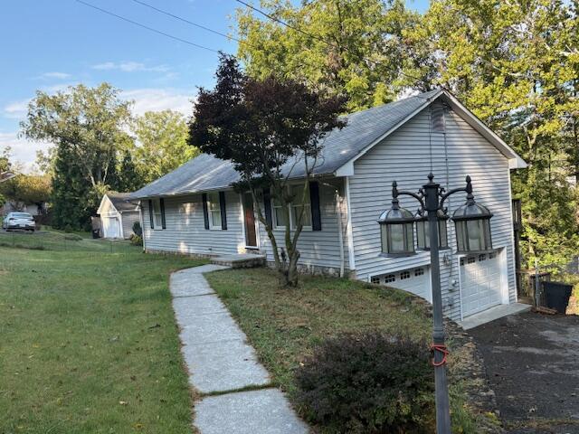 a front view of a house with a yard and trees