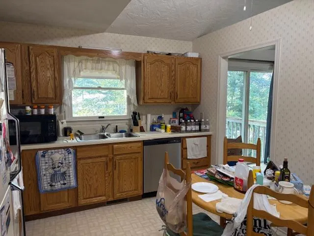 a kitchen with a window dining table and chairs