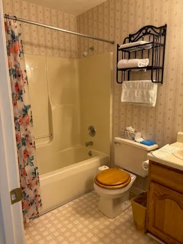 a bathroom with a sink toilet and shower