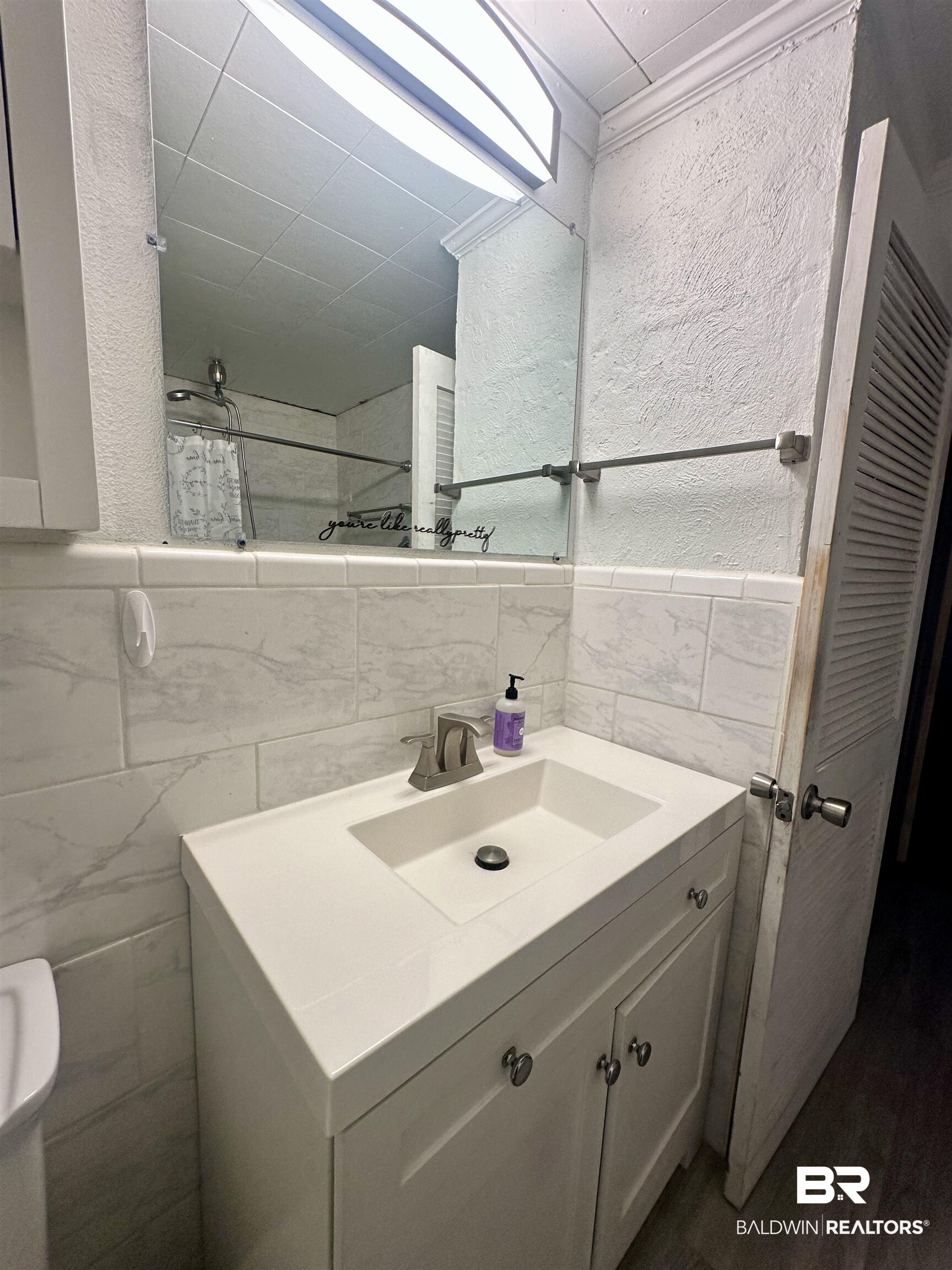 1206 St Nicholas Avenue Brewton, AL 36426 - Photo 10 of 19 Bathroom featuring vanity, toilet, and tile walls