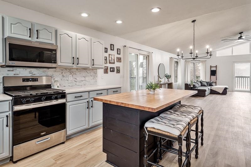 186 Lake Summerset Road Davis, IL 61019 - Photo 12 of 58 a kitchen with sink a microwave a stove and cabinets