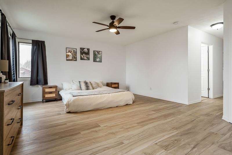 186 Lake Summerset Road Davis, IL 61019 - Photo 15 of 58 a spacious bedroom with a bed and a ceiling fan