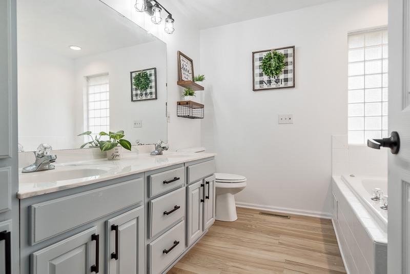 186 Lake Summerset Road Davis, IL 61019 - Photo 16 of 58 a spacious bathroom with a double vanity sink a toilet and a window