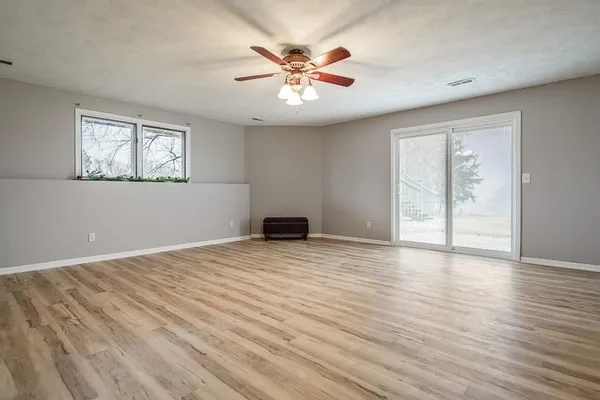wooden floor in an empty room with a window