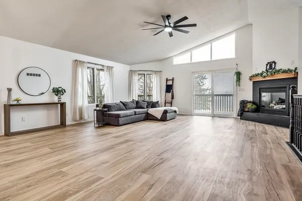 a living room with furniture and a wooden floor