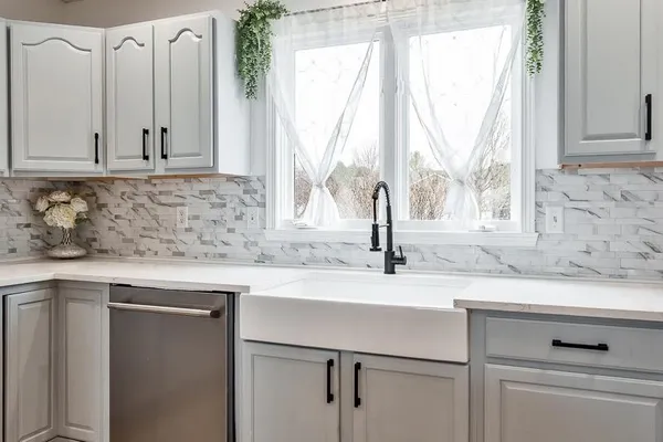 a kitchen with stainless steel appliances a table chairs refrigerator and stove