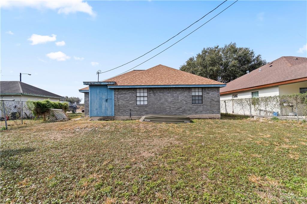 106 Rosa Priego Street Donna, TX 78537 - Photo 22 of 25 Rear view of house with a yard