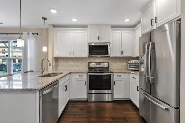 a kitchen with a sink stove and cabinets