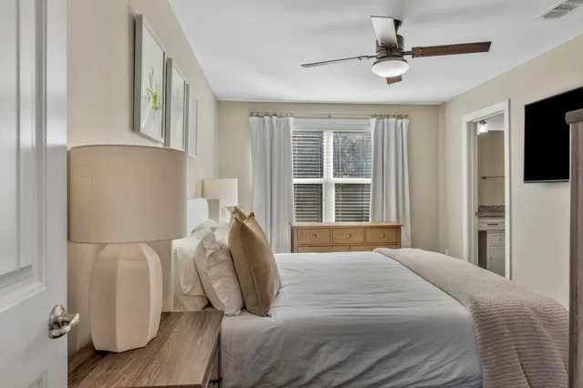 a bedroom with a bed and window with lamp