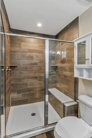 a bedroom with a bed and a ceiling fan