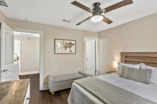a bathroom with a granite countertop toilet and a sink
