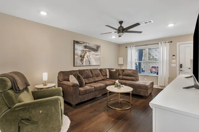 a view of a dining room with furniture a chandelier and wooden floor