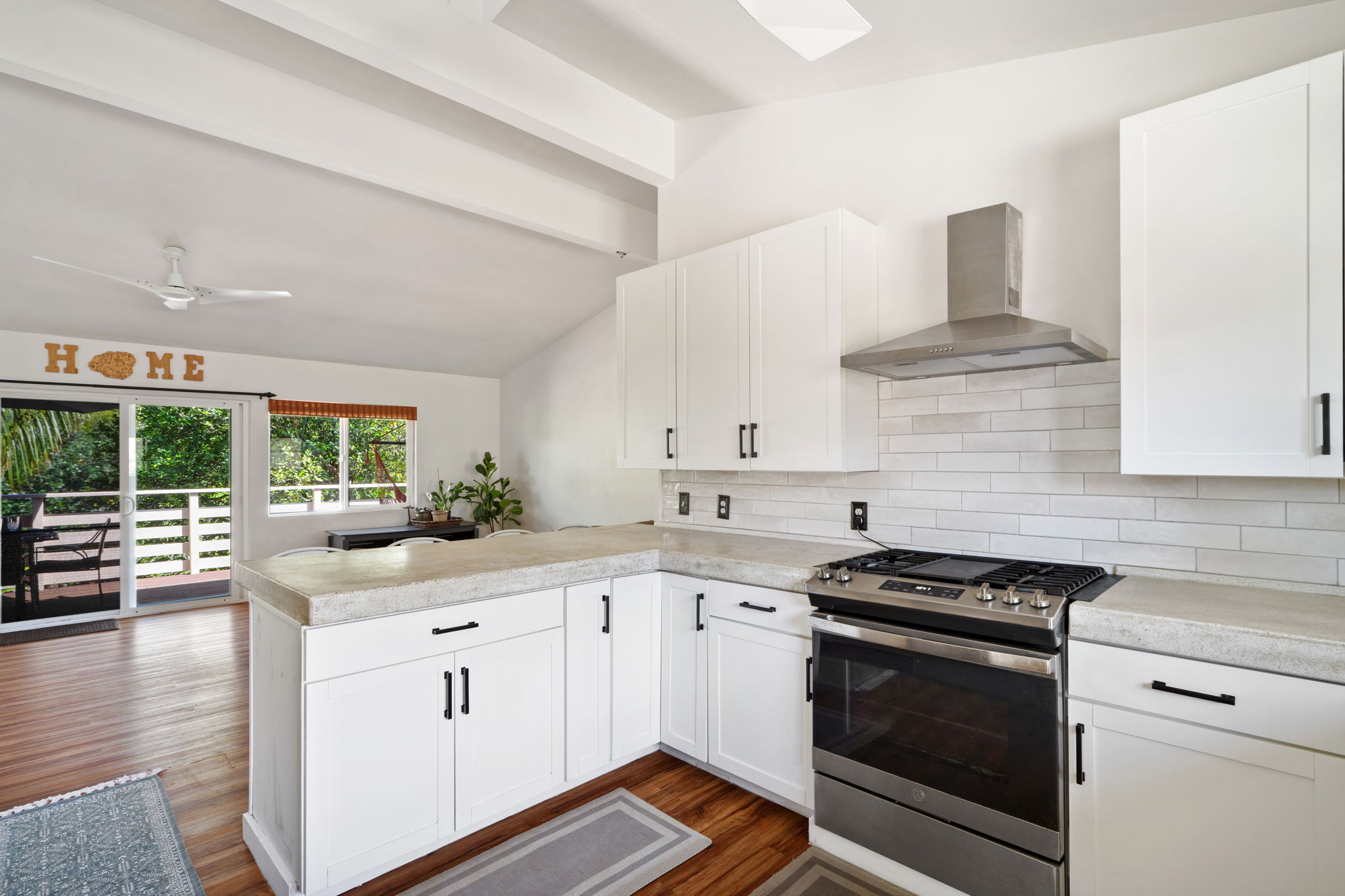 6100 Kawaihau Road Kapaa, HI 96746 - Photo 5 of 22 a kitchen with stainless steel appliances granite countertop a stove and a white cabinets