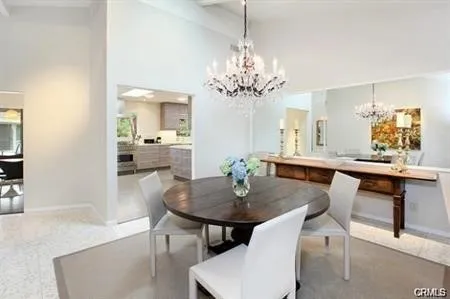 a view of a dining room with furniture and chandelier