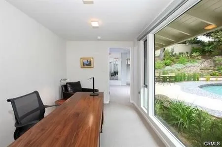 a view of a bedroom with a bed and wooden floor