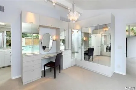 a view of a bathroom with a bathtub a chandelier and a mirror