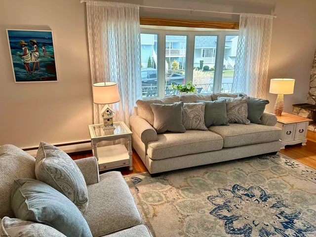 a living room with furniture and large window