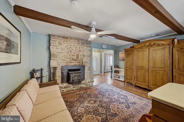 a large kitchen with kitchen island a stove a sink a dining table and chairs