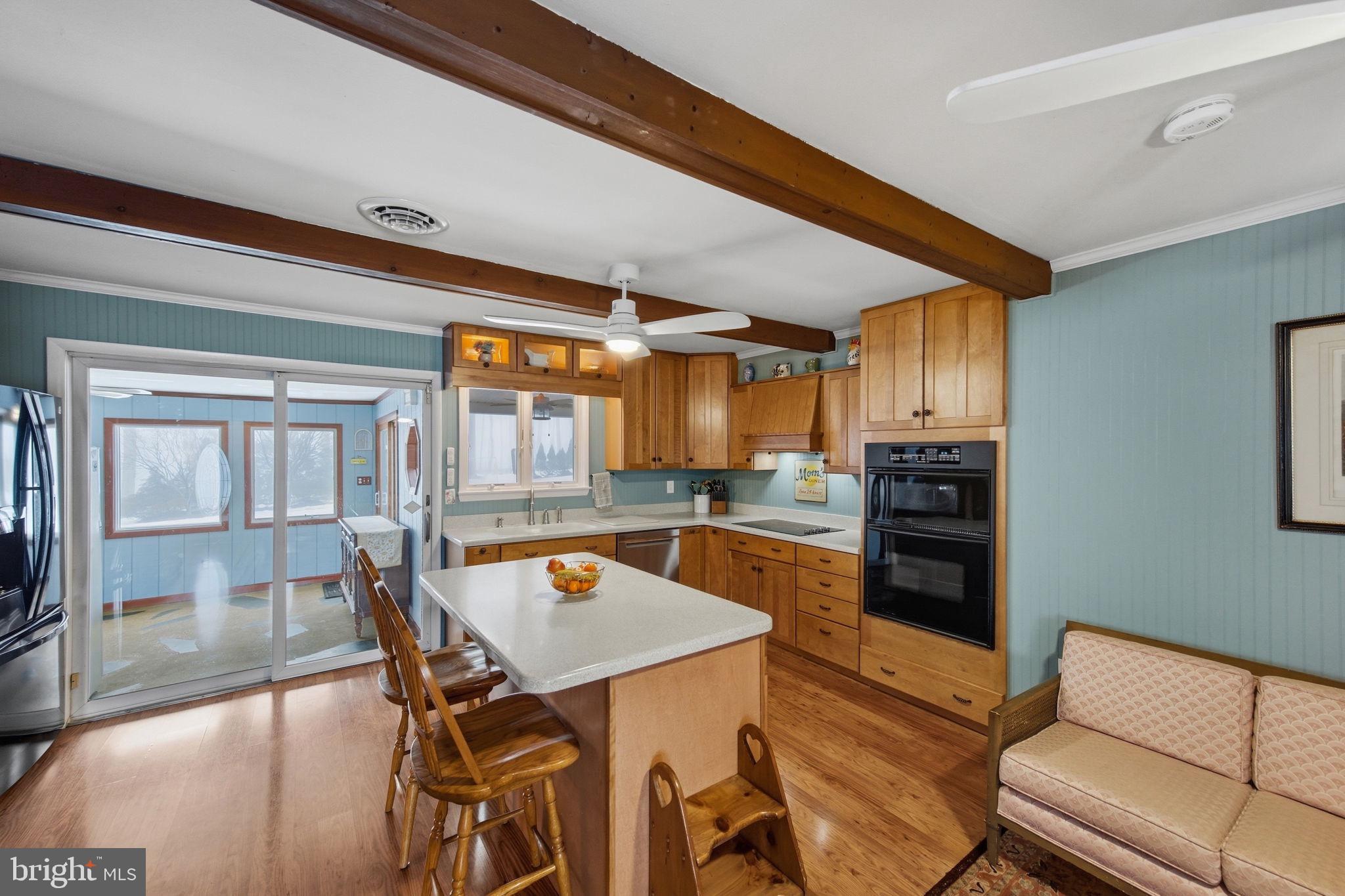 3975 Street Road Street, MD 21154 - Photo 17 of 78 a dining hall with stainless steel appliances kitchen island granite countertop a dining table chairs and a living room view