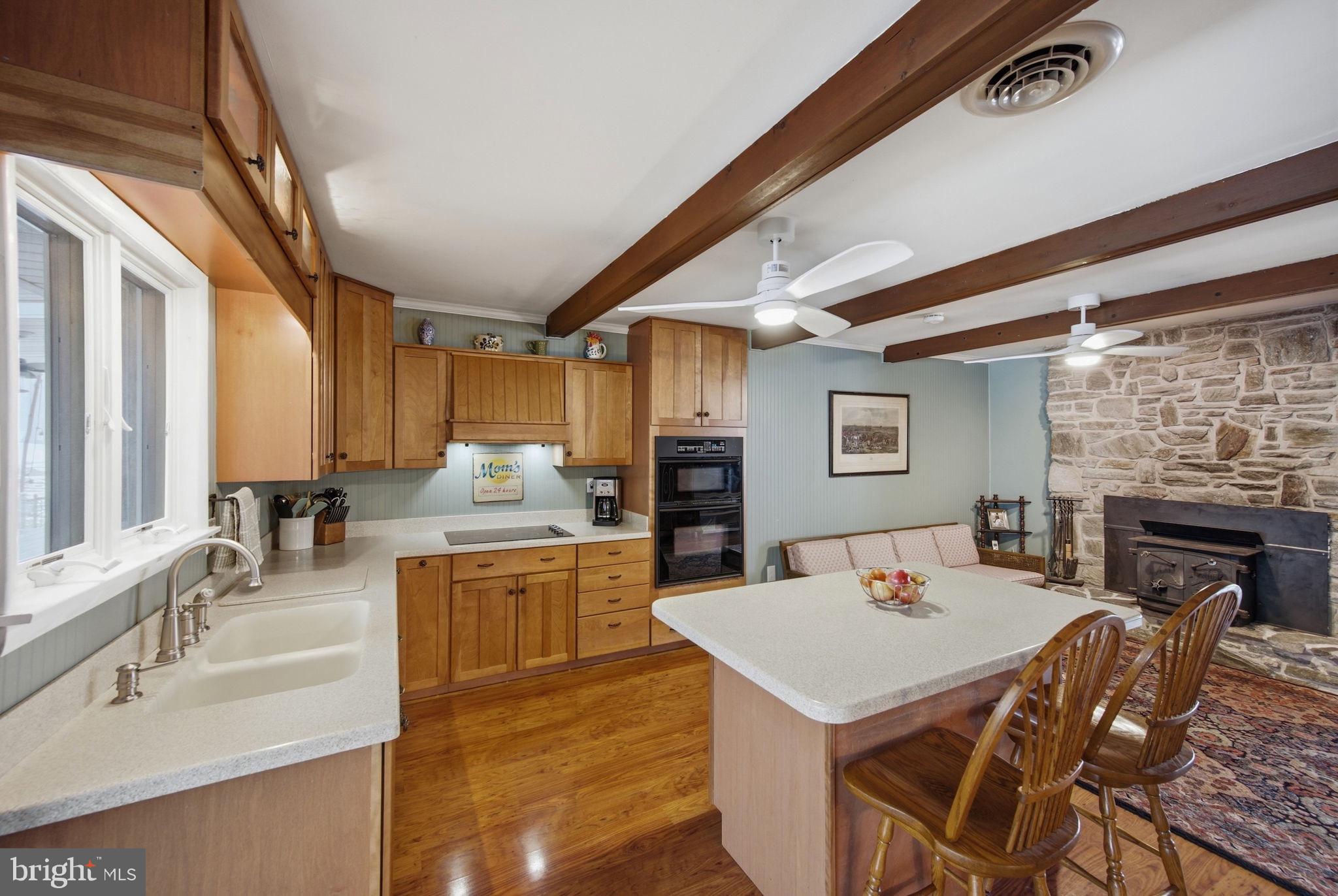 3975 Street Road Street, MD 21154 - Photo 18 of 78 a large kitchen with kitchen island a stove a sink a dining table and chairs