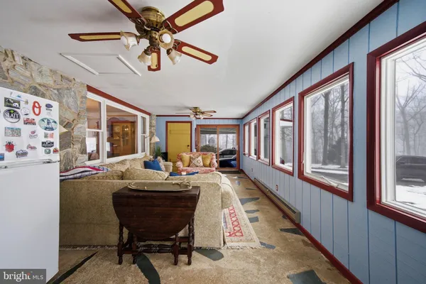 a living room with table chairs and a rug