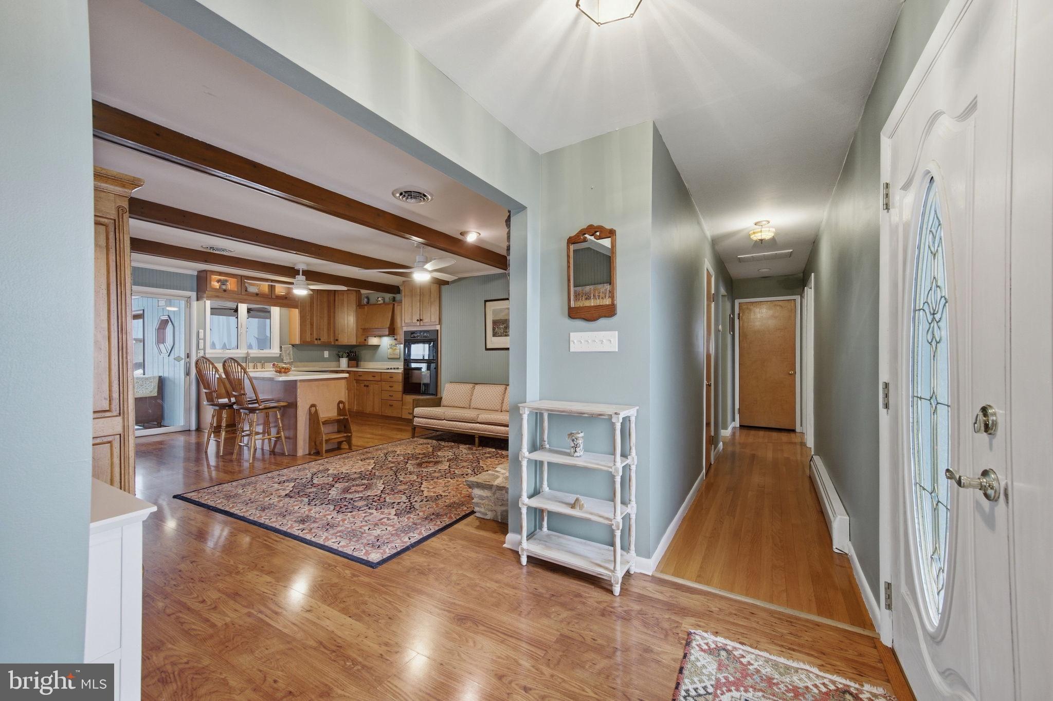 3975 Street Road Street, MD 21154 - Photo 37 of 78 a living room with table chairs and a rug