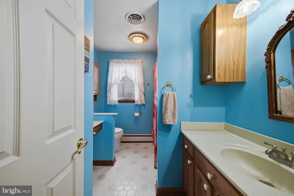 a front view of a house with a yard and tree s