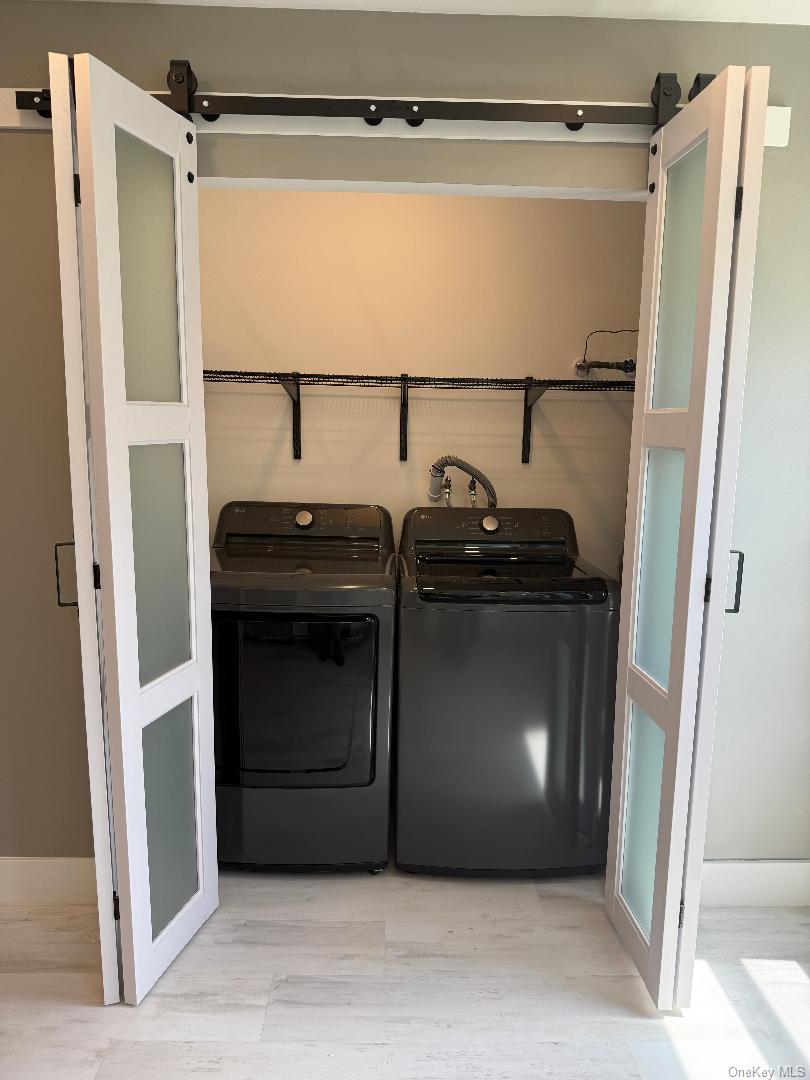 379 Larchmont Court Ridge, NY 11961 - Photo 10 of 17 a view of a utility room with washer and dryer
