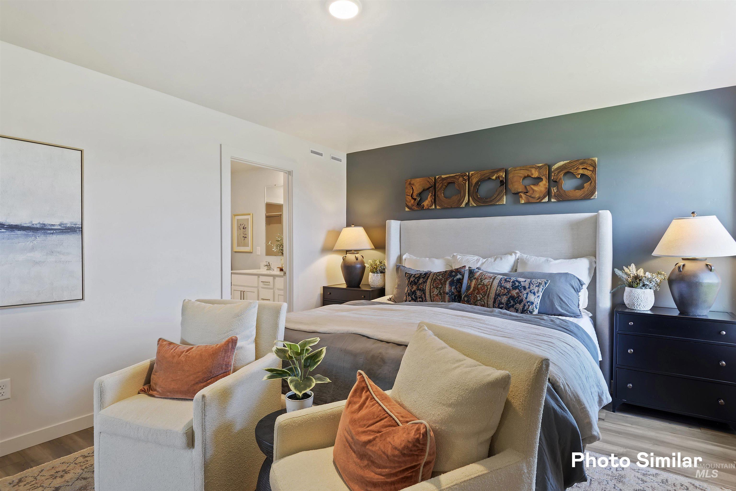 15182 Cumulus Way Caldwell, ID 83607 - Photo 12 of 26 Bedroom featuring wood finished floors and connected bathroom