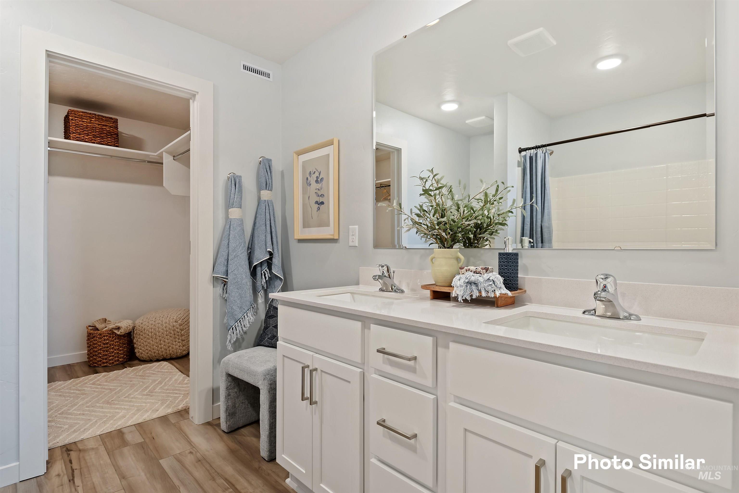 15182 Cumulus Way Caldwell, ID 83607 - Photo 13 of 26 Full bath with a spacious closet, double vanity, and light wood-type flooring
