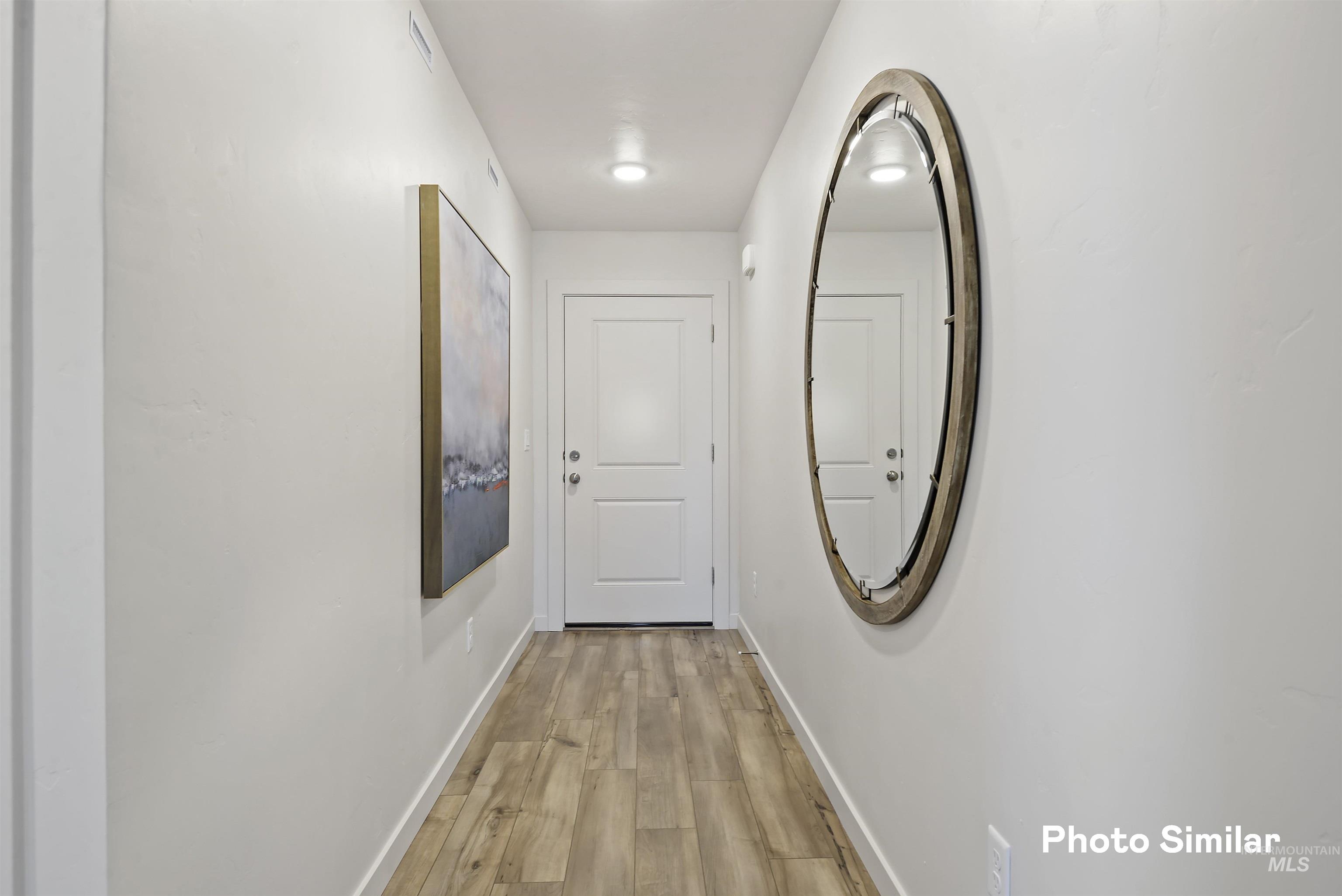 15182 Cumulus Way Caldwell, ID 83607 - Photo 21 of 26 Corridor with light wood finished floors and baseboards