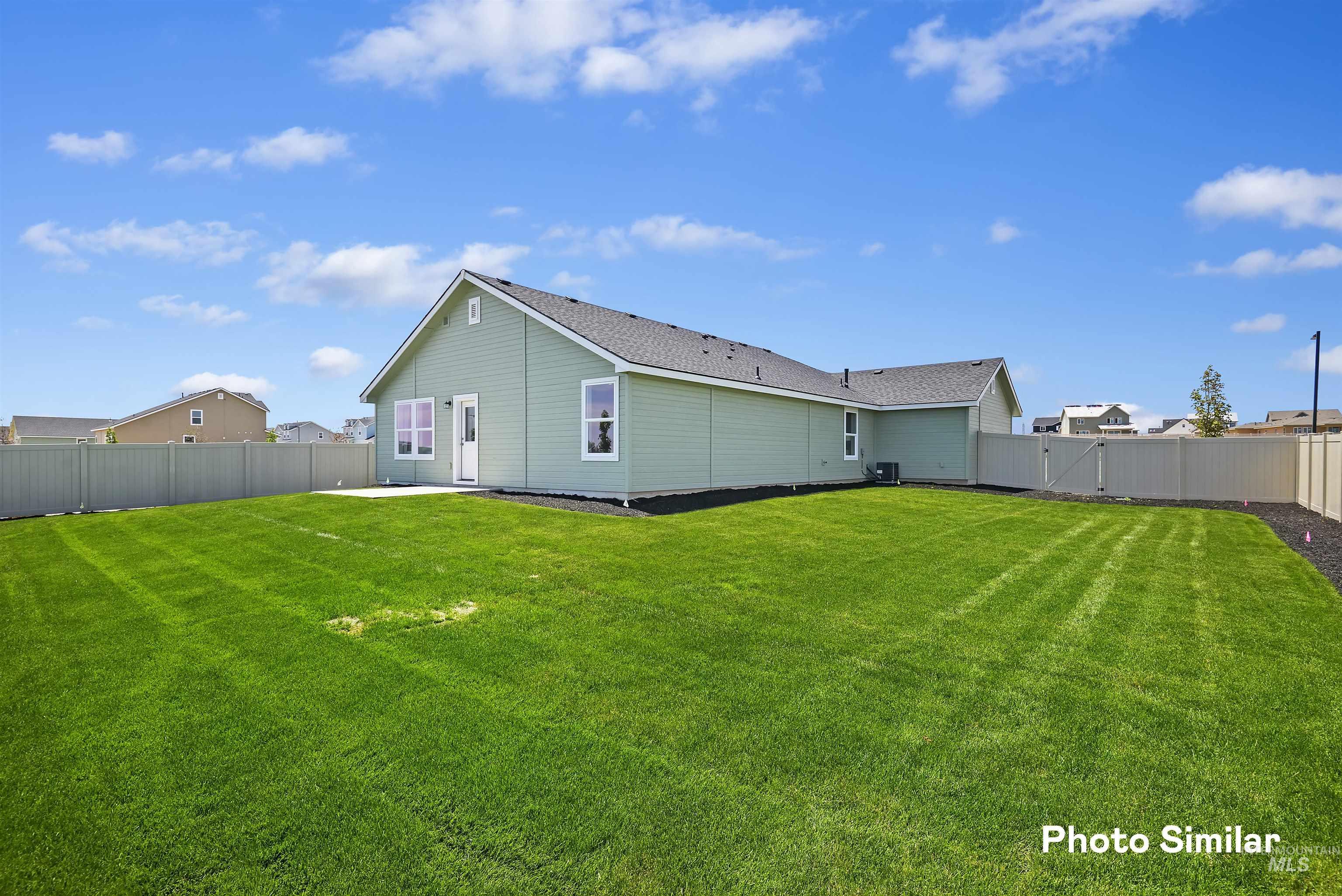 15182 Cumulus Way Caldwell, ID 83607 - Photo 23 of 26 Back of house featuring a fenced backyard, a gate, and a patio