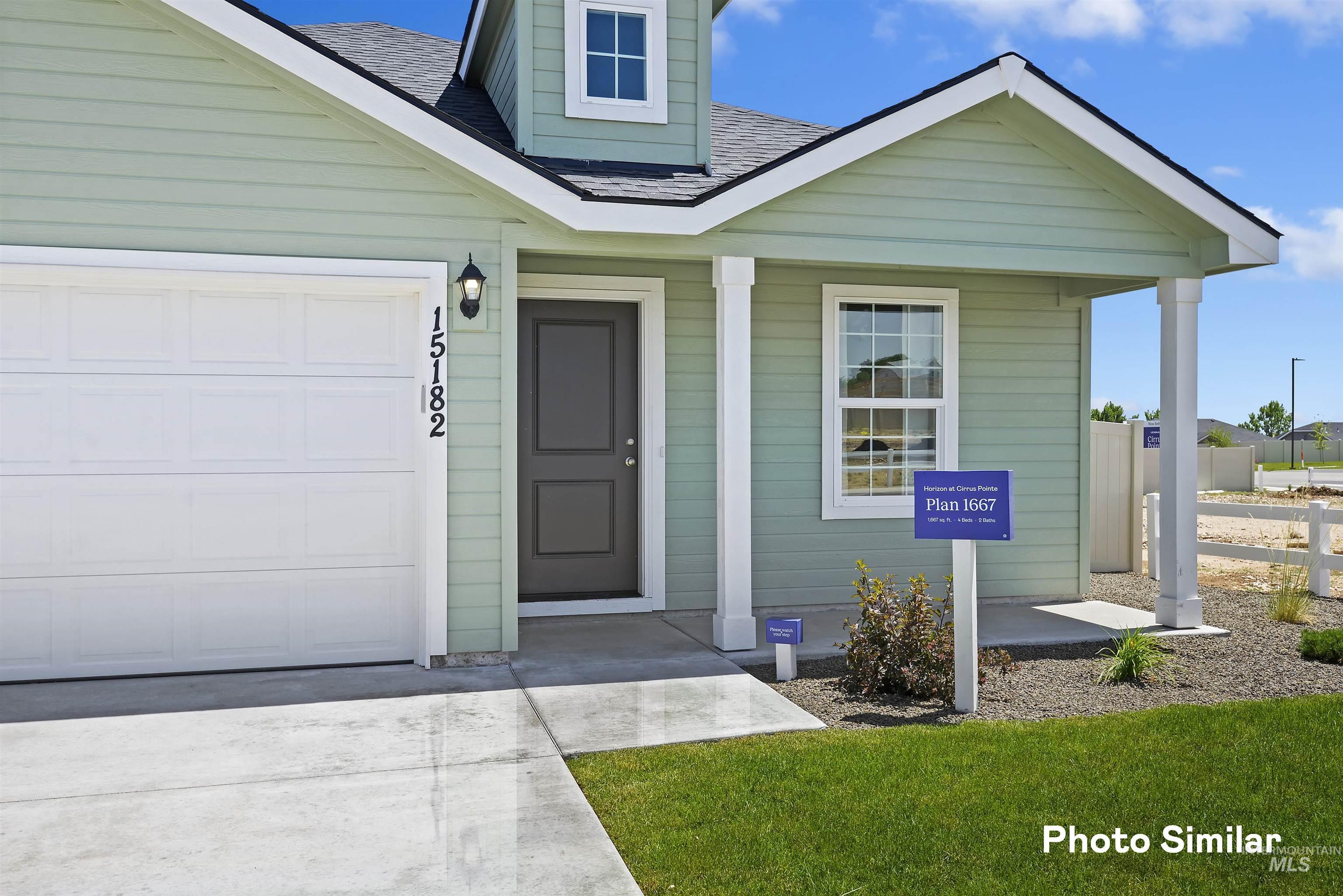 15182 Cumulus Way Caldwell, ID 83607 - Photo 24 of 26 Entrance to property with a garage, roof with shingles, a porch, and driveway