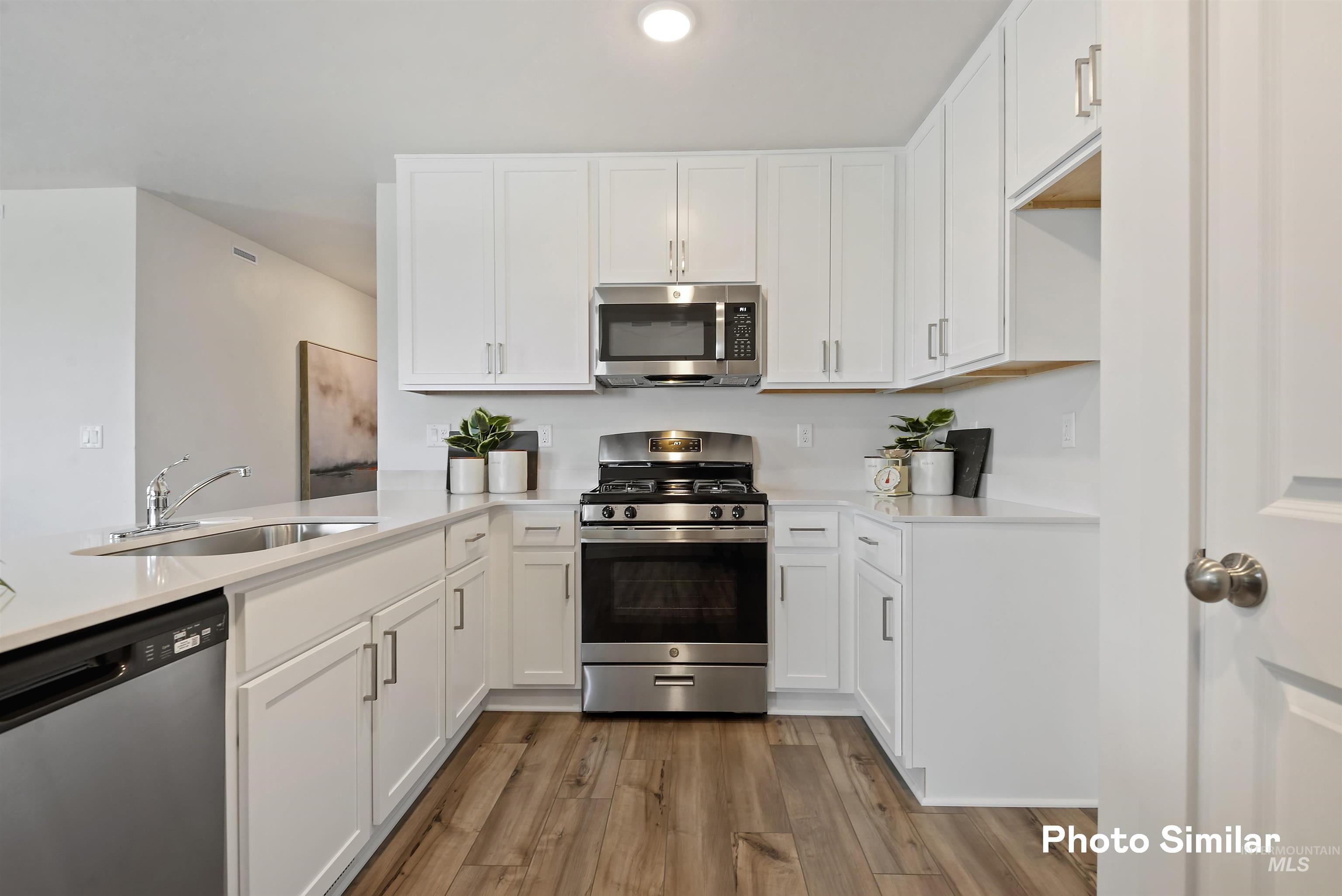15182 Cumulus Way Caldwell, ID 83607 - Photo 8 of 26 Kitchen featuring stainless steel appliances and white cabinets