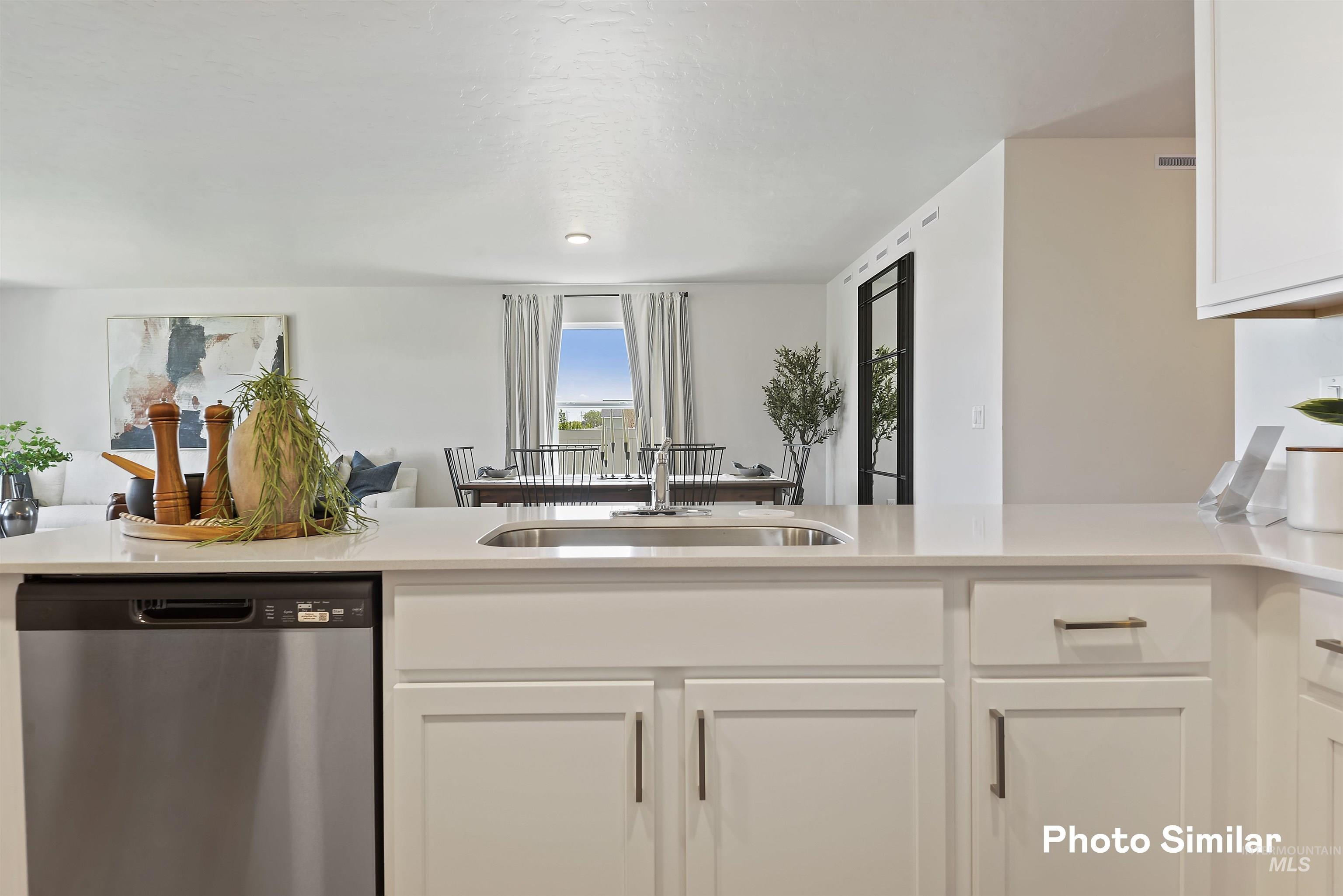 15182 Cumulus Way Caldwell, ID 83607 - Photo 9 of 26 Kitchen with dishwasher, white cabinetry, and light stone counters