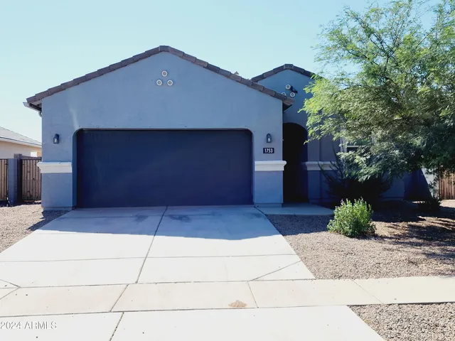 a front view of a house with garage