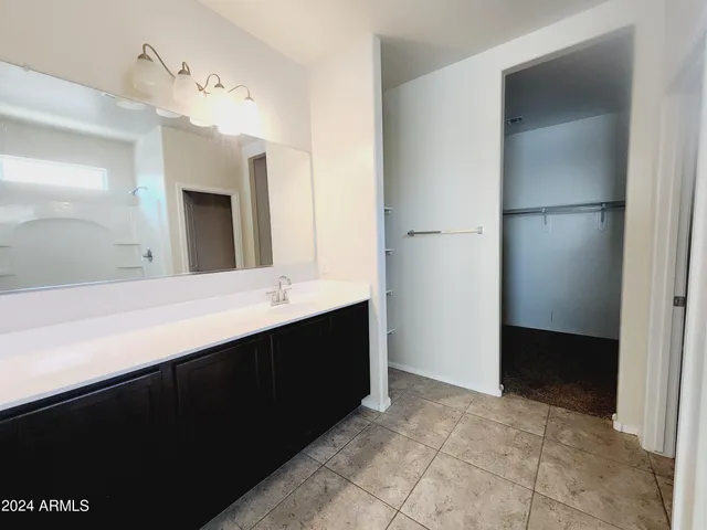 a bathroom with a double vanity sink a and mirror