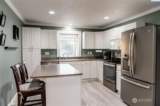 304 East 2nd Street Prescott, WA 99348 - Photo 11 of 24 a kitchen with granite countertop a refrigerator stove microwave and sink