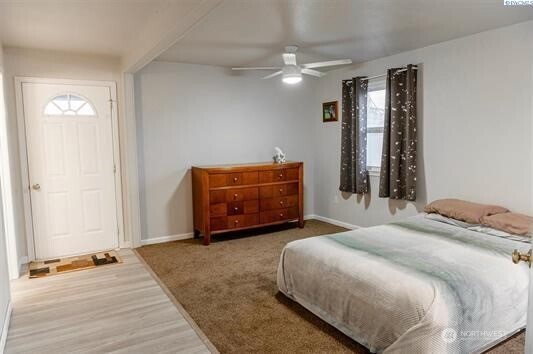 304 East 2nd Street Prescott, WA 99348 - Photo 16 of 24 a spacious bedroom with a bed and a chandelier