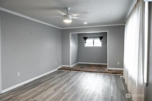 304 East 2nd Street Prescott, WA 99348 - Photo 7 of 24 a view of an empty room with wooden floor and a window