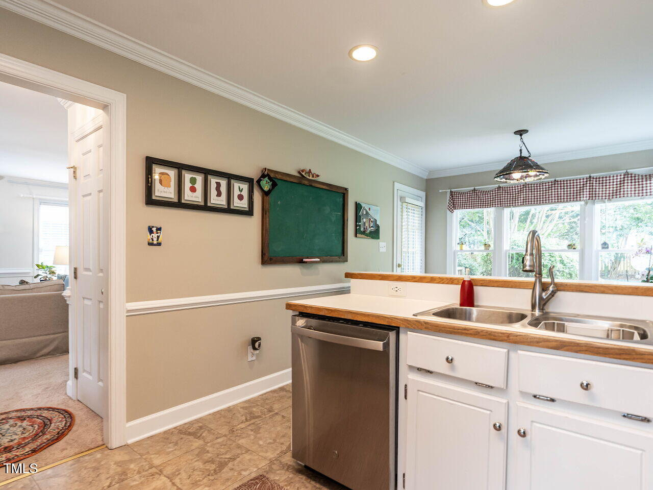 9205 Dawnshire Road Raleigh, NC 27615 - Photo 13 of 30 a kitchen with a sink and a refrigerator